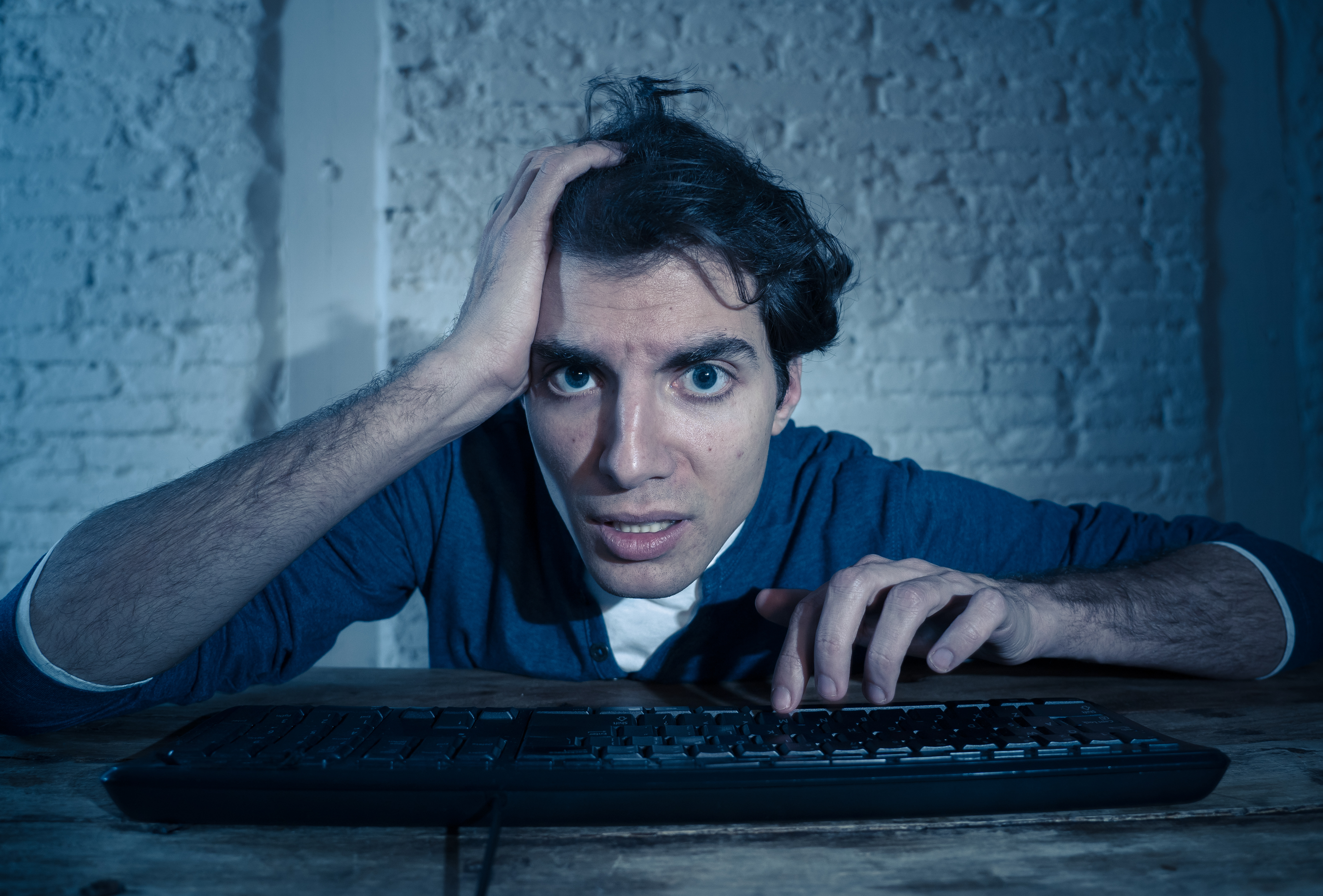 Addict young man alone at night watching porn.